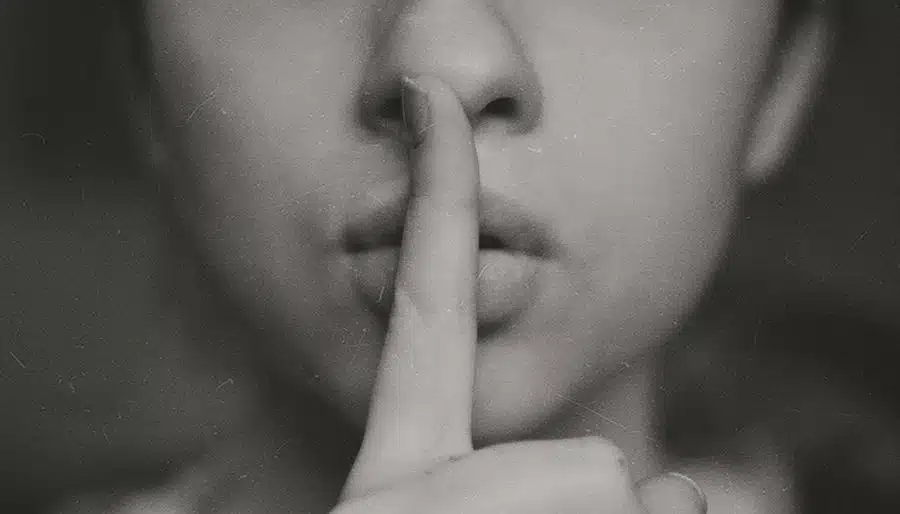 Shhh - Finger in Front of Lips Signalling Quiet.